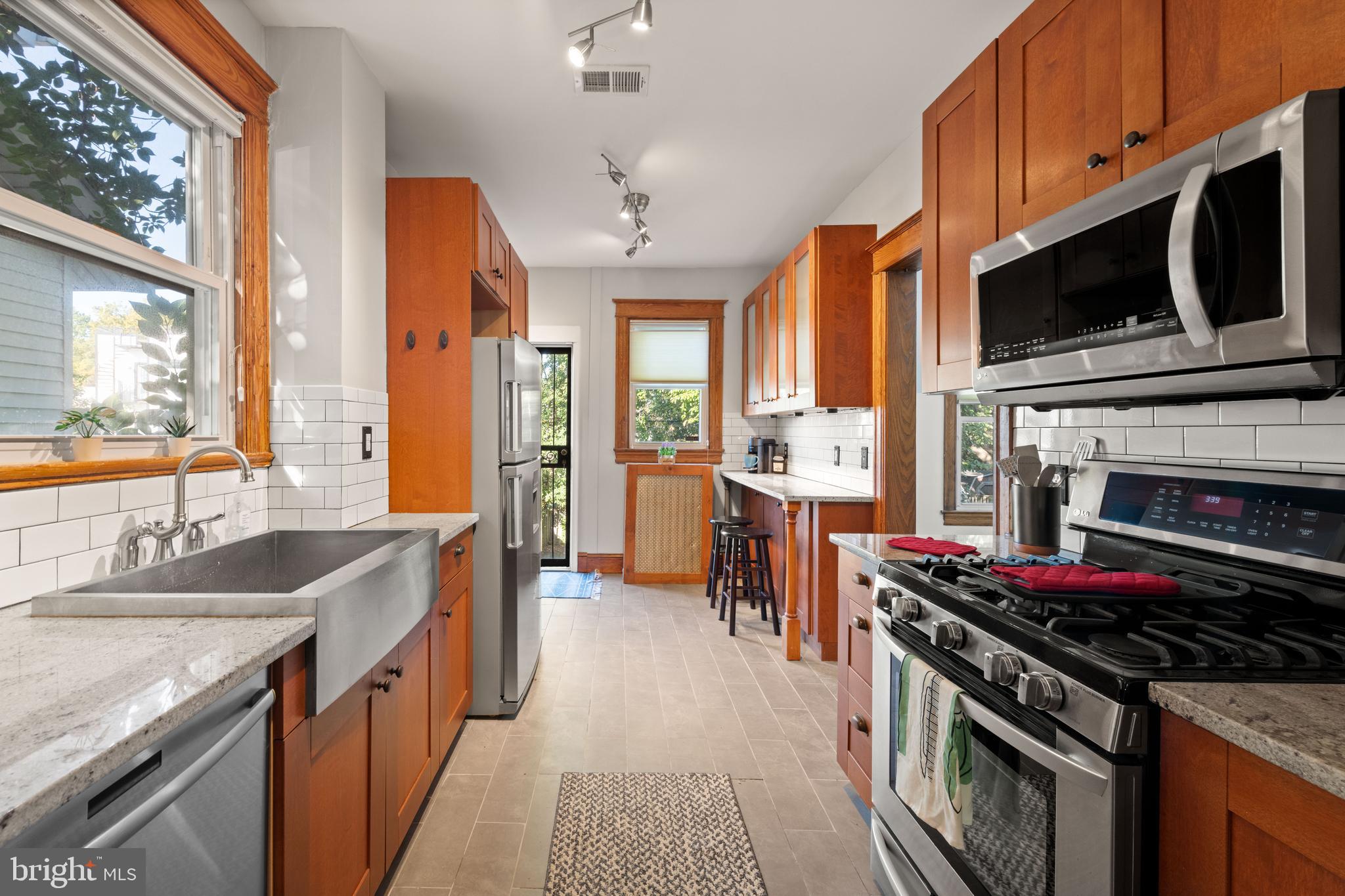 4110 4th Street Northwest Washington, DC 20011 - Photo 17 of 46 a kitchen with stainless steel appliances a stove a sink and a microwave
