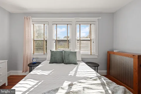 a bedroom with a large bed and a window