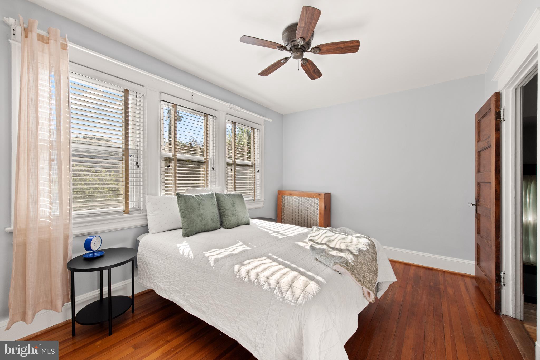 4110 4th Street Northwest Washington, DC 20011 - Photo 27 of 46 a bedroom with a bed a dresser and a wooden floor