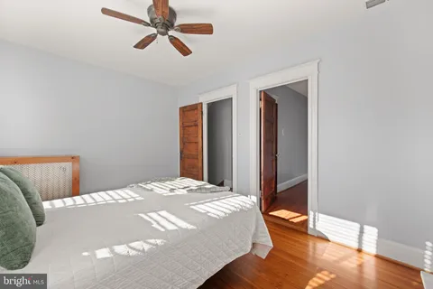 a bedroom with a bed and wooden floor