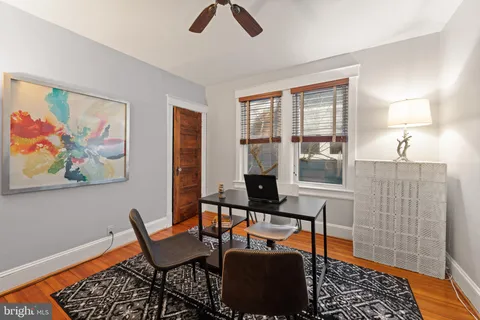 a work room with furniture and a rug