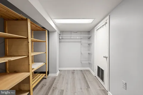 a view of walk in closet with empty racks