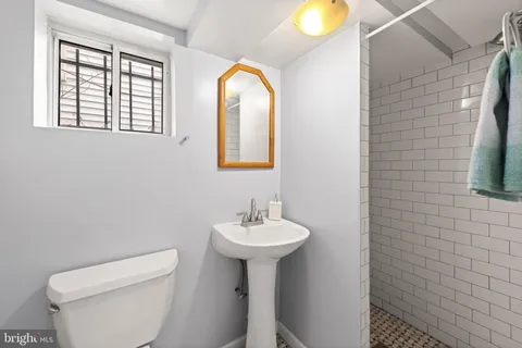 a bathroom with a sink a mirror and a toilet
