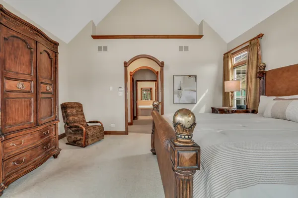 a spacious bathroom with a tub sink and mirror