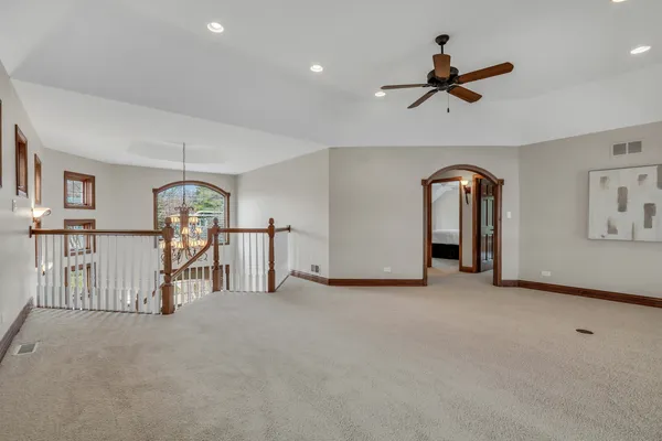 a living room with furniture a chandelier and a potted plant