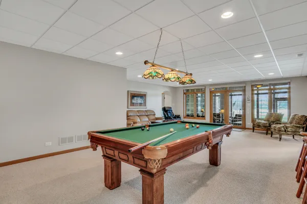 a living room with furniture a flat screen tv and a large window