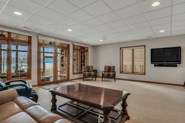 a living room with furniture and large windows