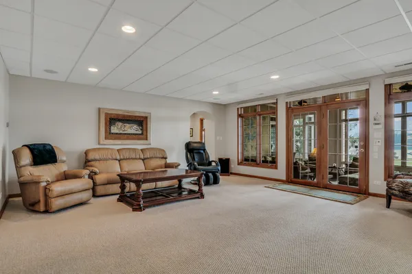 a bedroom with a bed couch and large window