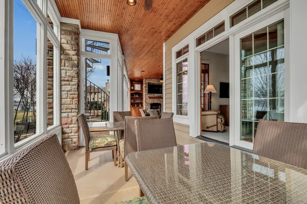 a living room with furniture large window and a fireplace