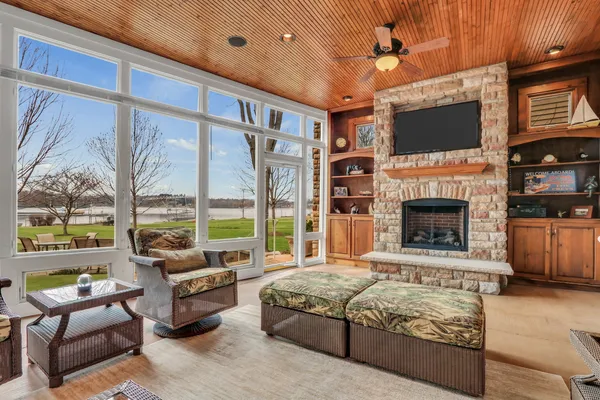 a living room with furniture and large windows