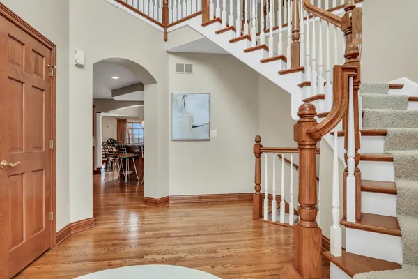 a view of entryway and hall with wooden floor