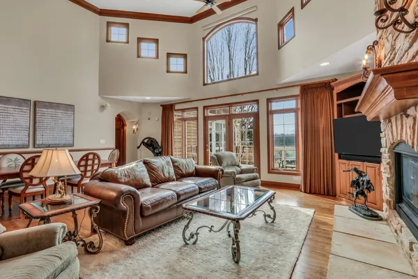 a living room with furniture a flat screen tv and a table