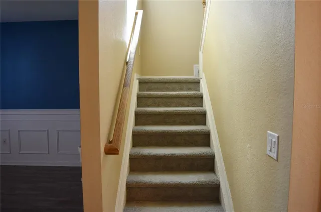 a view of staircase with white walls