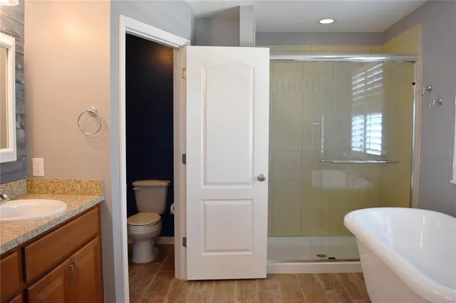 a bathroom with a sink a toilet and shower