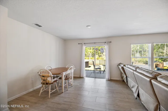 a spacious bedroom with a bed and a flat screen tv