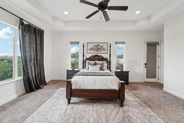 a bedroom with a bed and a large window