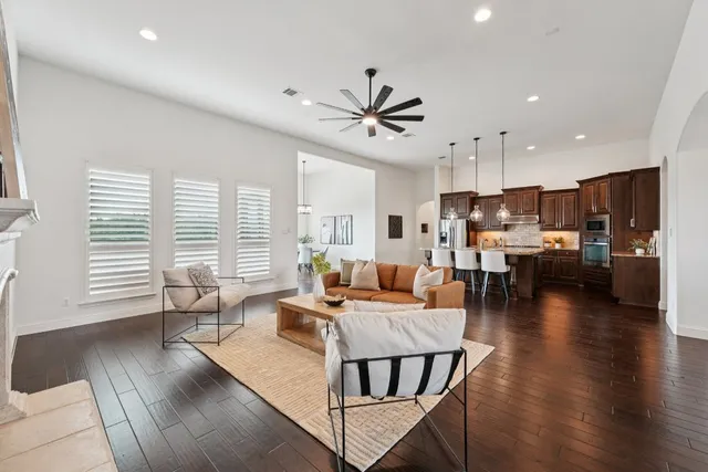 a living room with furniture and kitchen view