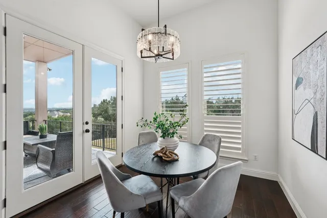 a view of a dining room with furniture wooden floor and a chandelier