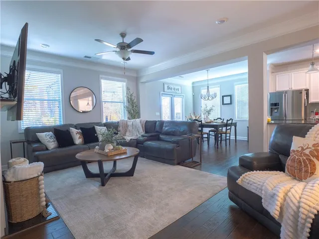 a living room with furniture and wooden floor