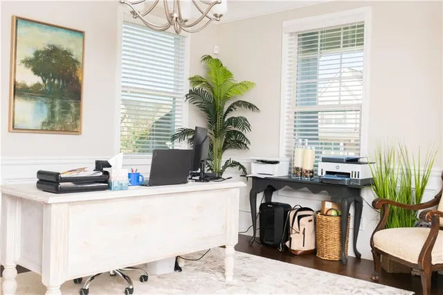 a dining room with furniture a potted plant and a window