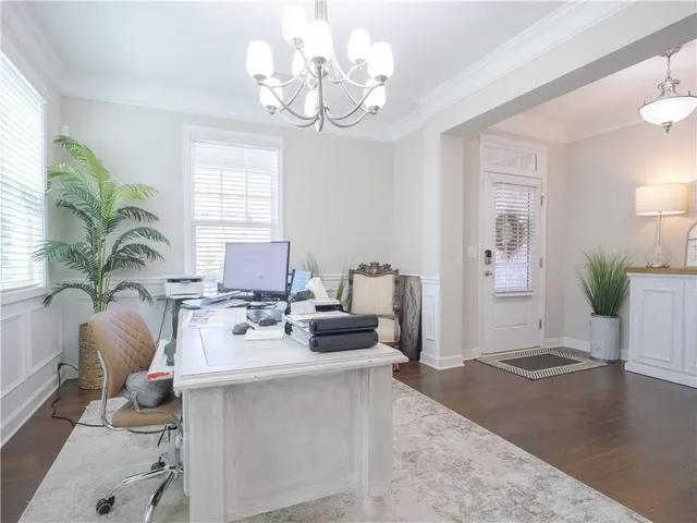 a living room with furniture a chandelier and a window