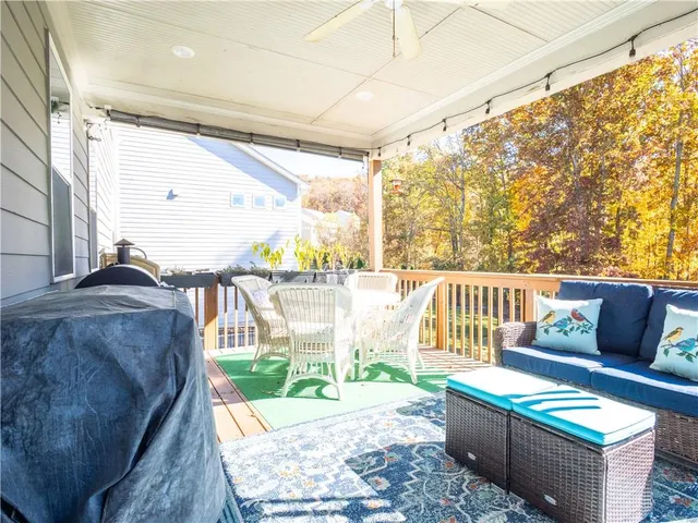 a living room filled with furniture and a large window