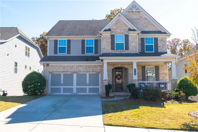 a front view of a house with garden