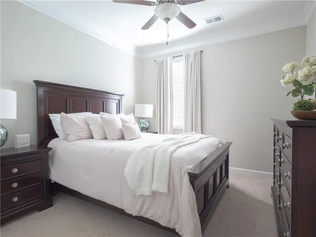 a spacious bedroom with a bed and a chandelier
