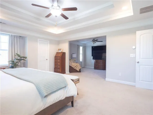 a spacious bedroom with a bed and a walk in closet