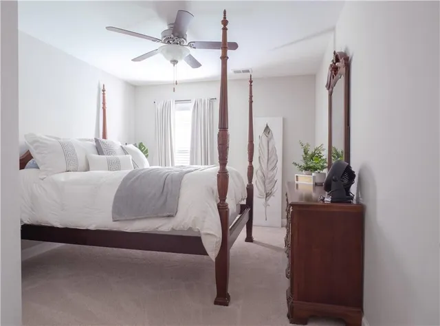 a bedroom with a bed and a potted plant