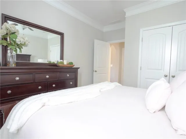 a bedroom with a bed and a large mirror
