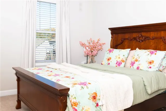 a bed sitting in a bedroom next to a window