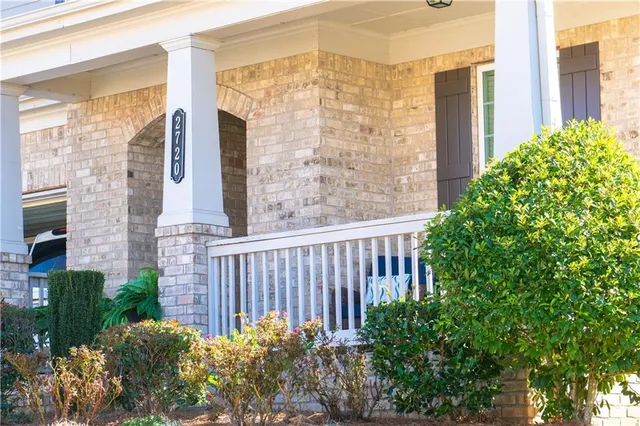 a view of a brick house with a flower plants