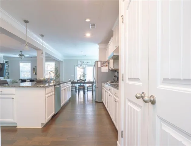 a kitchen with counter top space and wooden floor