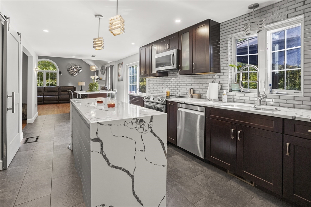 138 Walnut Street Douglas, MA 01516 - Photo 11 of 32 a kitchen with stainless steel appliances sink stove refrigerator and cabinets