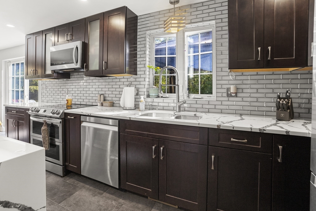 138 Walnut Street Douglas, MA 01516 - Photo 13 of 32 a kitchen with stainless steel appliances granite countertop a sink stove and cabinets