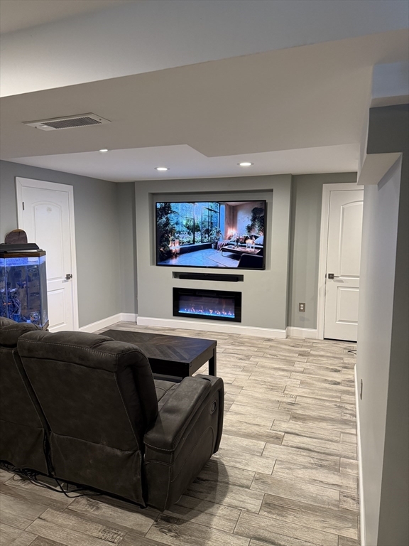 138 Walnut Street Douglas, MA 01516 - Photo 27 of 32 a living room with furniture a flat screen tv and a fireplace