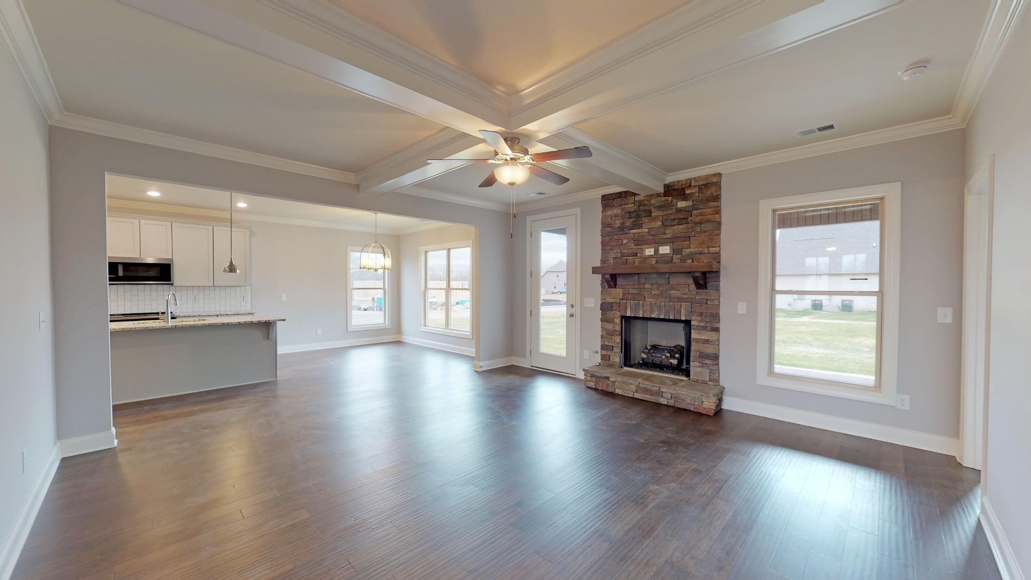 814 Ridgestone Place Lebanon, TN 37087 - Photo 3 of 16 a view of an empty room with a kitchen and a fireplace