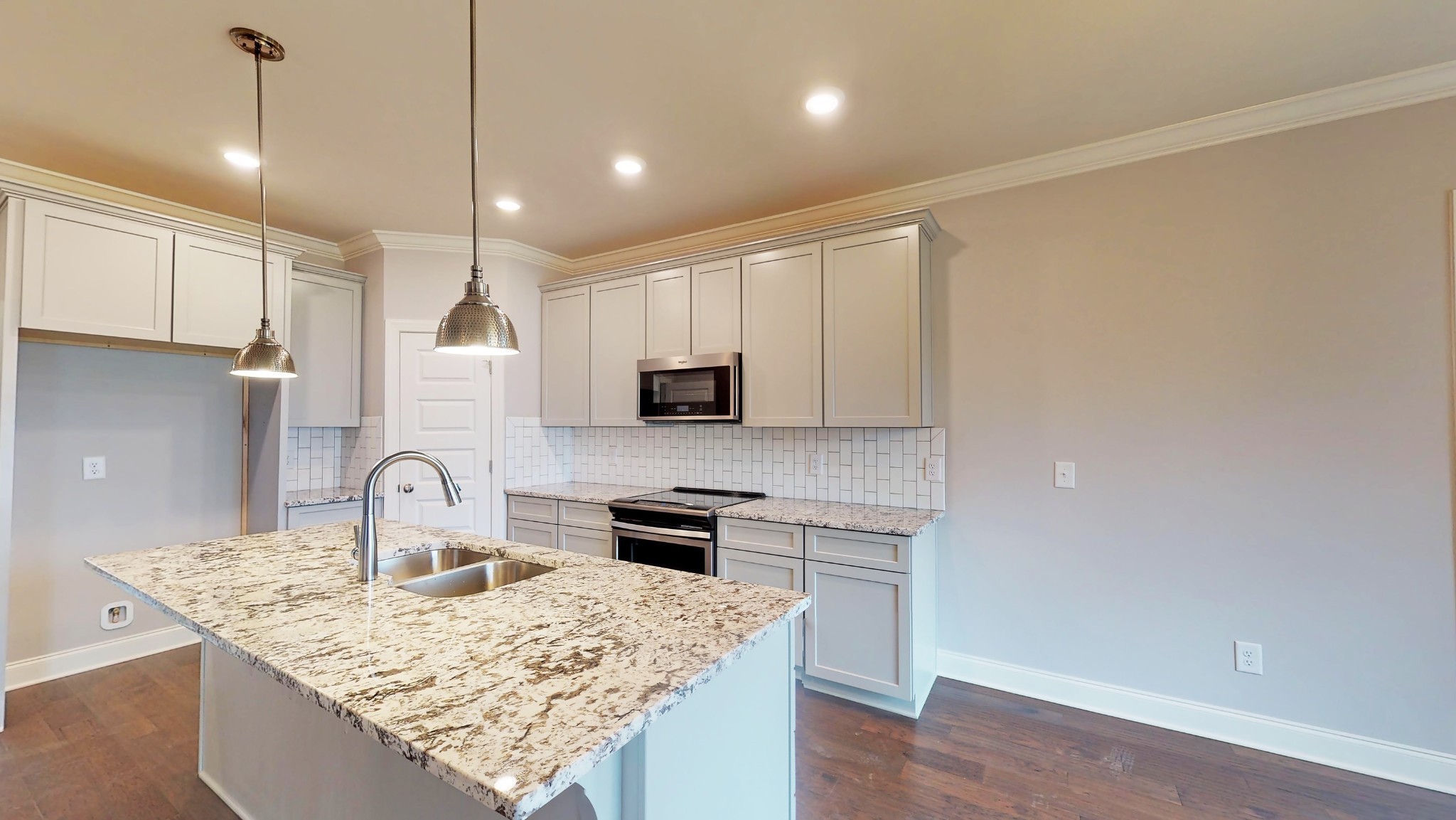 814 Ridgestone Place Lebanon, TN 37087 - Photo 6 of 16 a kitchen with granite countertop a sink a center island stainless steel appliances and cabinets