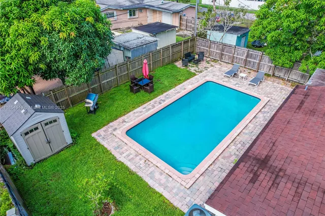 a view of a backyard with sitting area