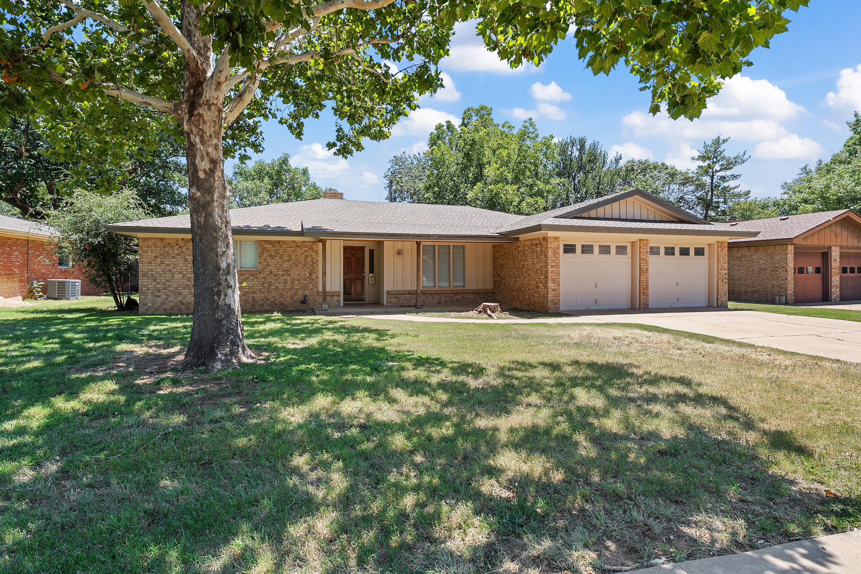 4113 62nd Drive Lubbock, TX 79413 - Photo 1 of 29 a front view of a house with a garden and yard