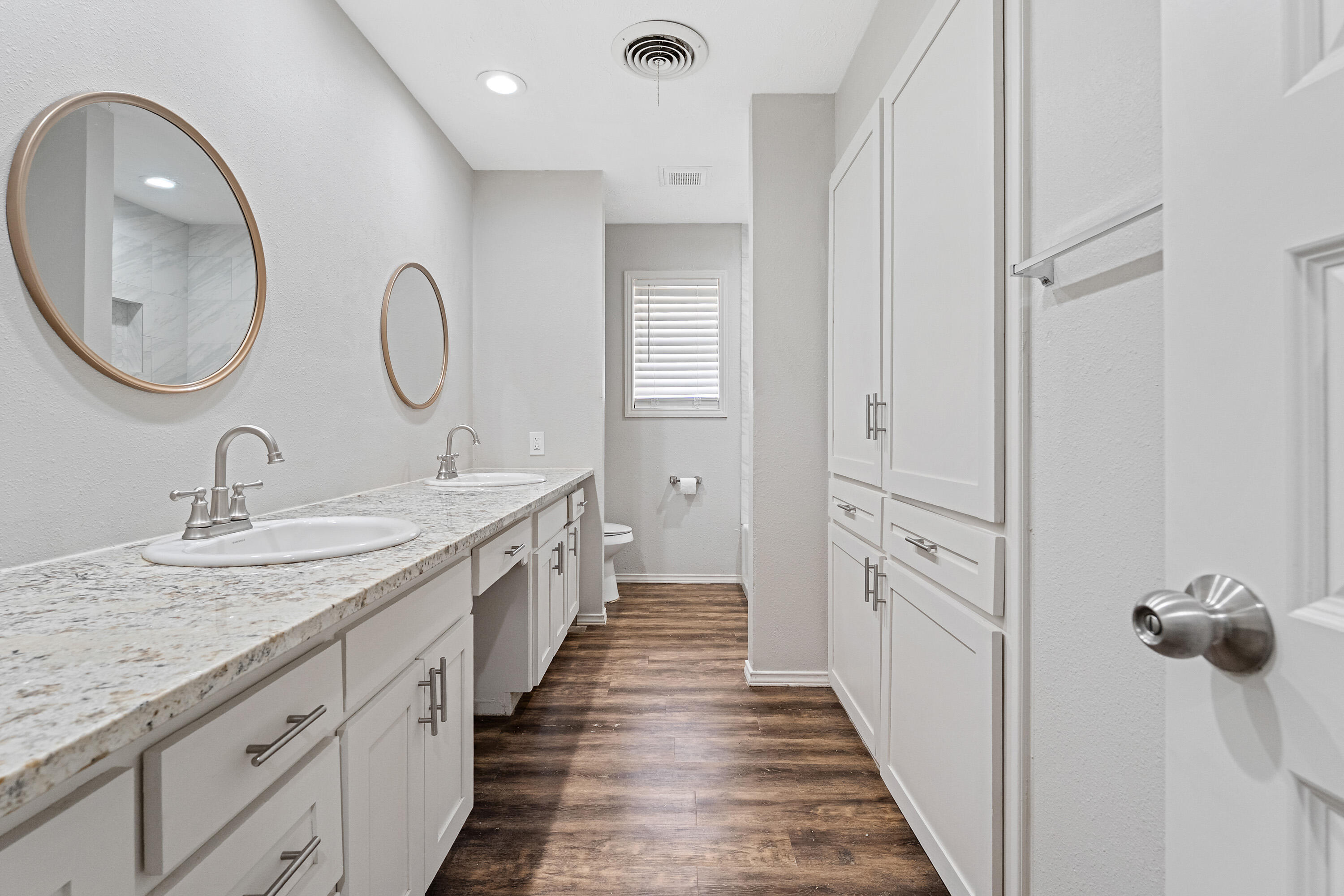 4113 62nd Drive Lubbock, TX 79413 - Photo 23 of 29 a spacious bathroom with a double vanity sink and a mirror