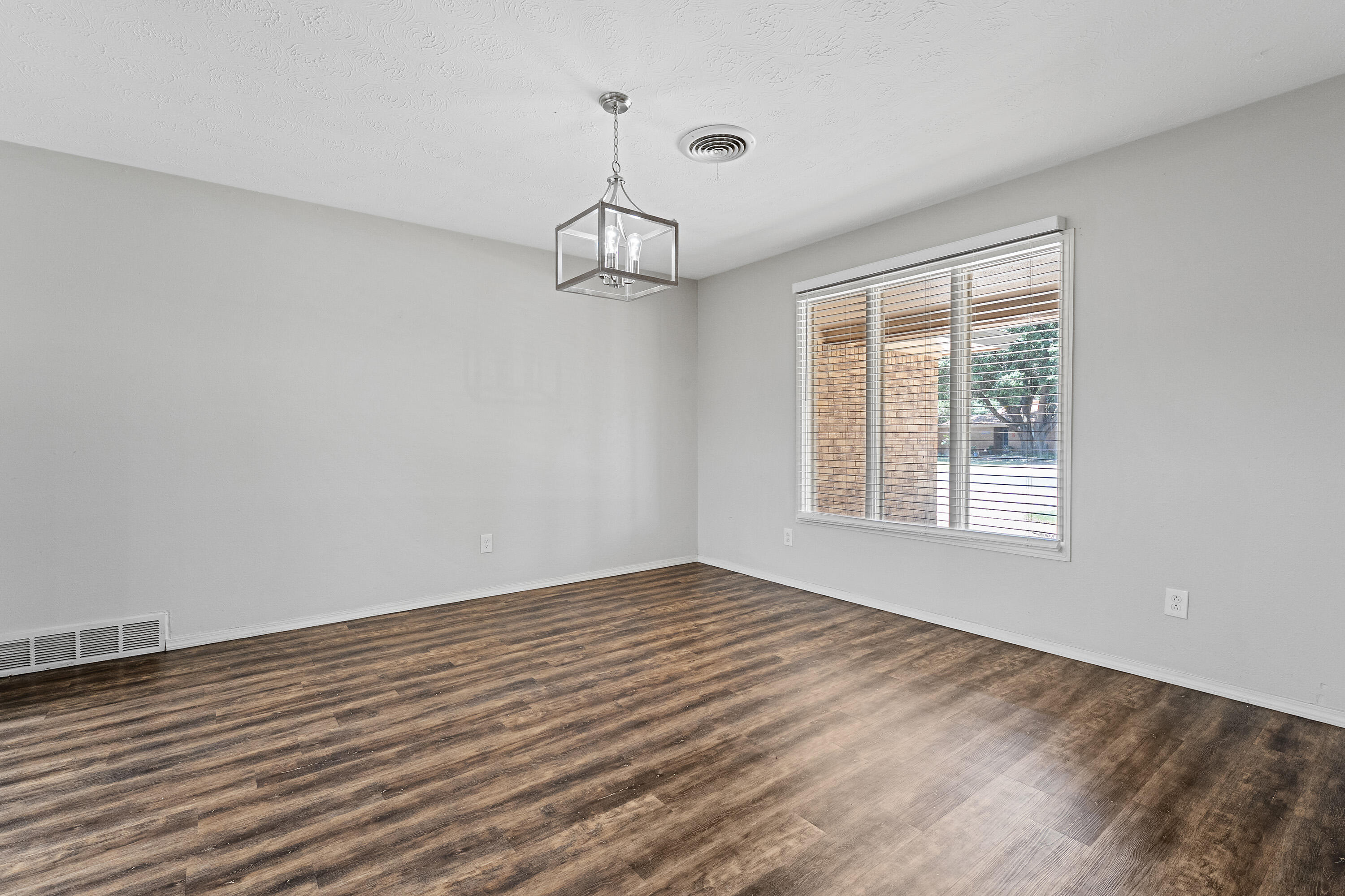 4113 62nd Drive Lubbock, TX 79413 - Photo 5 of 29 a view of an empty room with wooden floor and a window