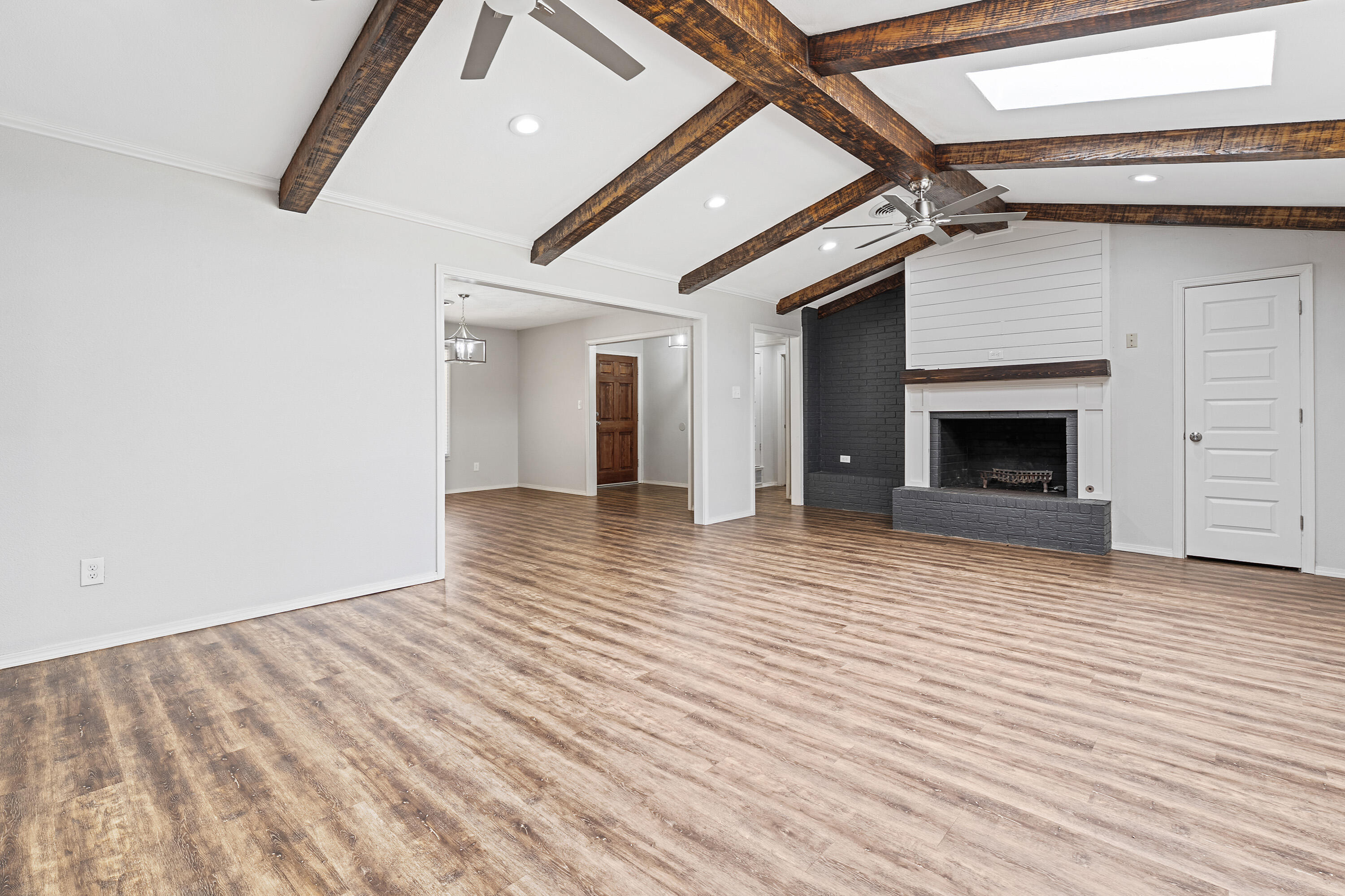 4113 62nd Drive Lubbock, TX 79413 - Photo 8 of 29 an empty room with wooden floor fireplace and windows