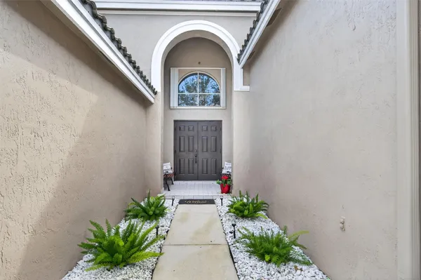 a front view of a house with a lot of flower plants
