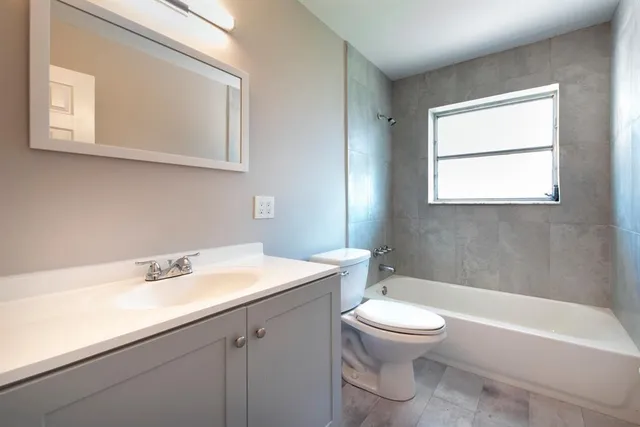 a bathroom with a sink a toilet and a bathtub