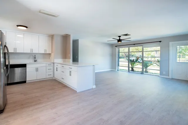 a view of a kitchen with a sink cabinets and a window