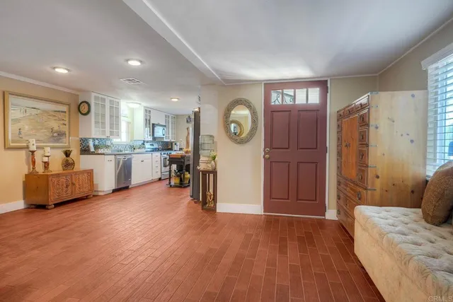 a view of a living room kitchen and a wooden floor