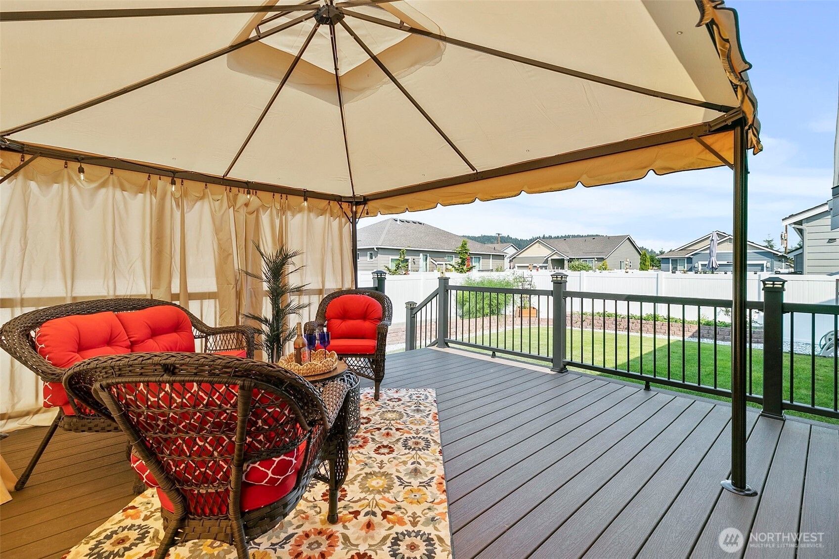 103 Hickory Avenue Southwest, Unit 35 Orting, WA 98360 - Photo 12 of 38 a view of a chairs and table in the wooden deck