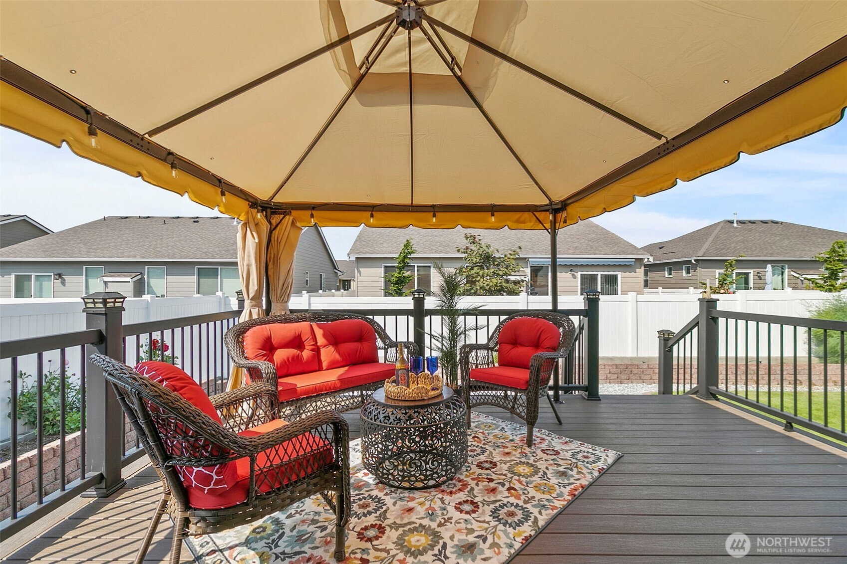 103 Hickory Avenue Southwest, Unit 35 Orting, WA 98360 - Photo 14 of 38 an outdoor sitting area with furniture and umbrella